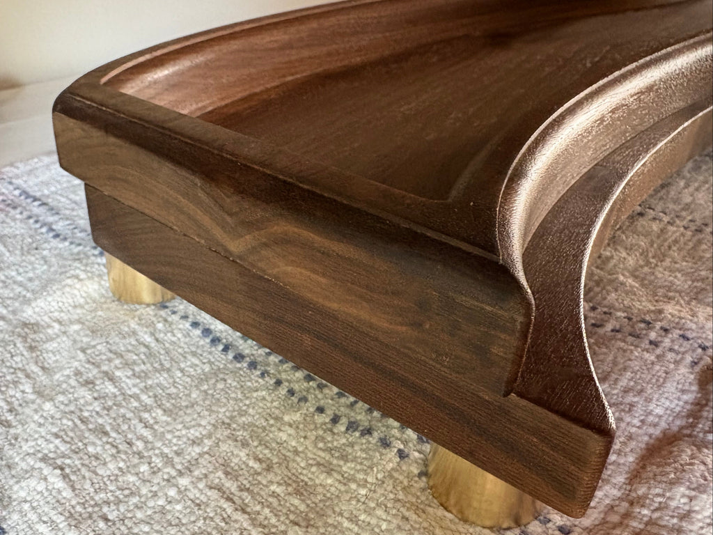 The Solitude walnut centerpiece tray angled view showing hand-finished surface and clean form
