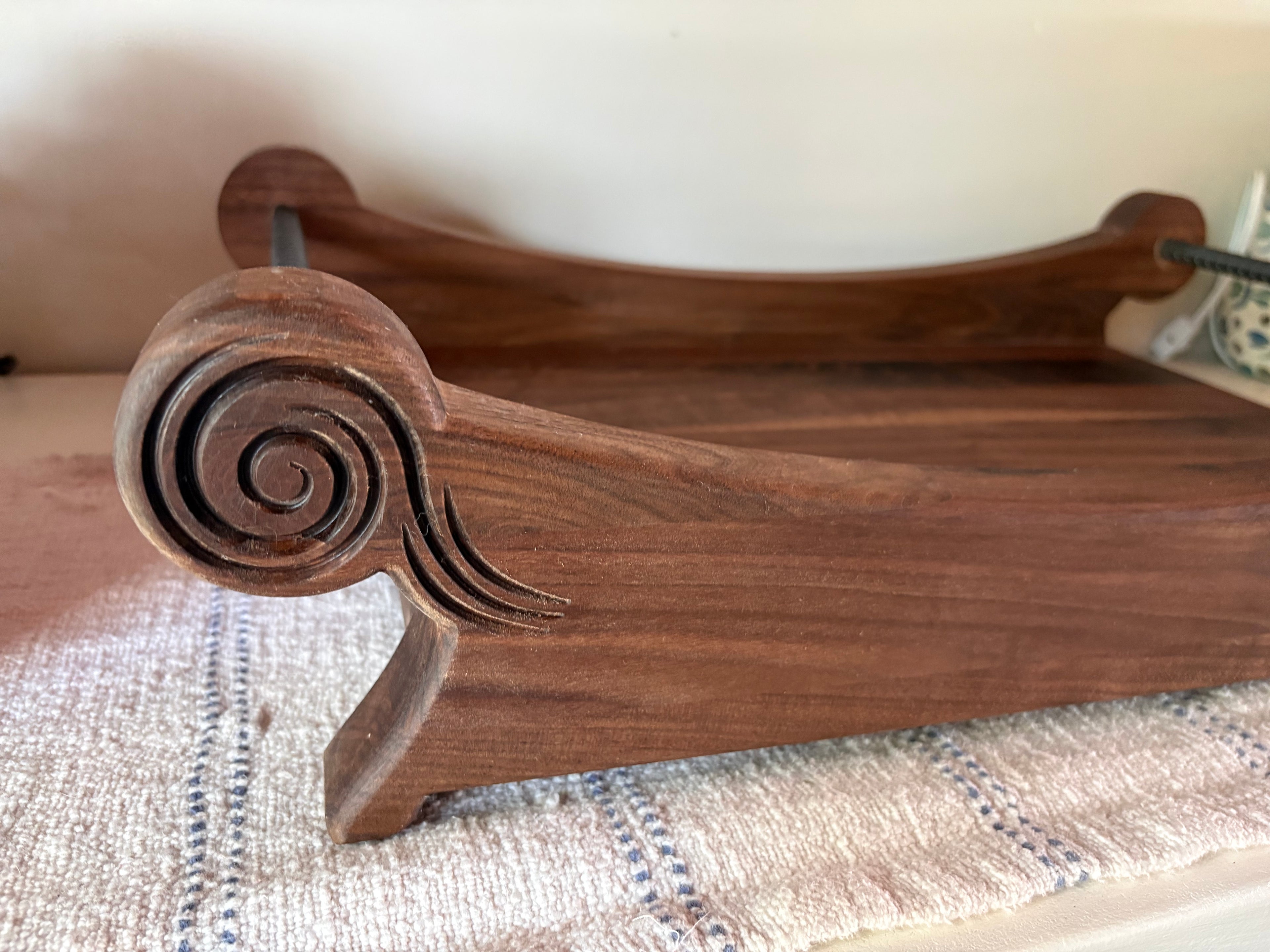 Close-up of The Nocturne solid walnut centerpiece showing hand-finished satin grain detail
